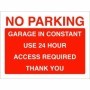 No parking garage in constant use sign with bold red and white text