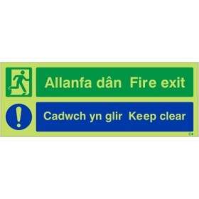 Glow in the dark fire exit keep clear sign in English and Welsh with safety symbols