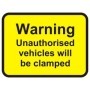 Warning unauthorised vehicles will be clamped sign with bold black text on yellow background