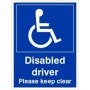 Disabled driver please keep clear sign with wheelchair symbol and bold white text on blue background