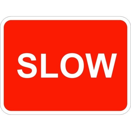 Slow traffic sign with bold white text on red background